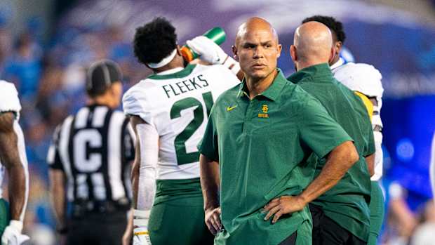 Baylor head coach Dave Aranda standing during warmups against BYU.